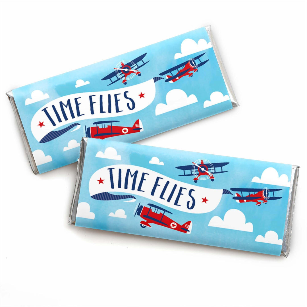 Vintage airplane-themed candy bar wrappers with the text 'TIME FLIES' and illustrations of red and blue airplanes against a blue sky with white clouds.