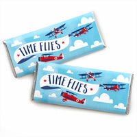 Vintage airplane-themed candy bar wrappers with the text 'TIME FLIES' and illustrations of red and blue airplanes against a blue sky with white clouds.