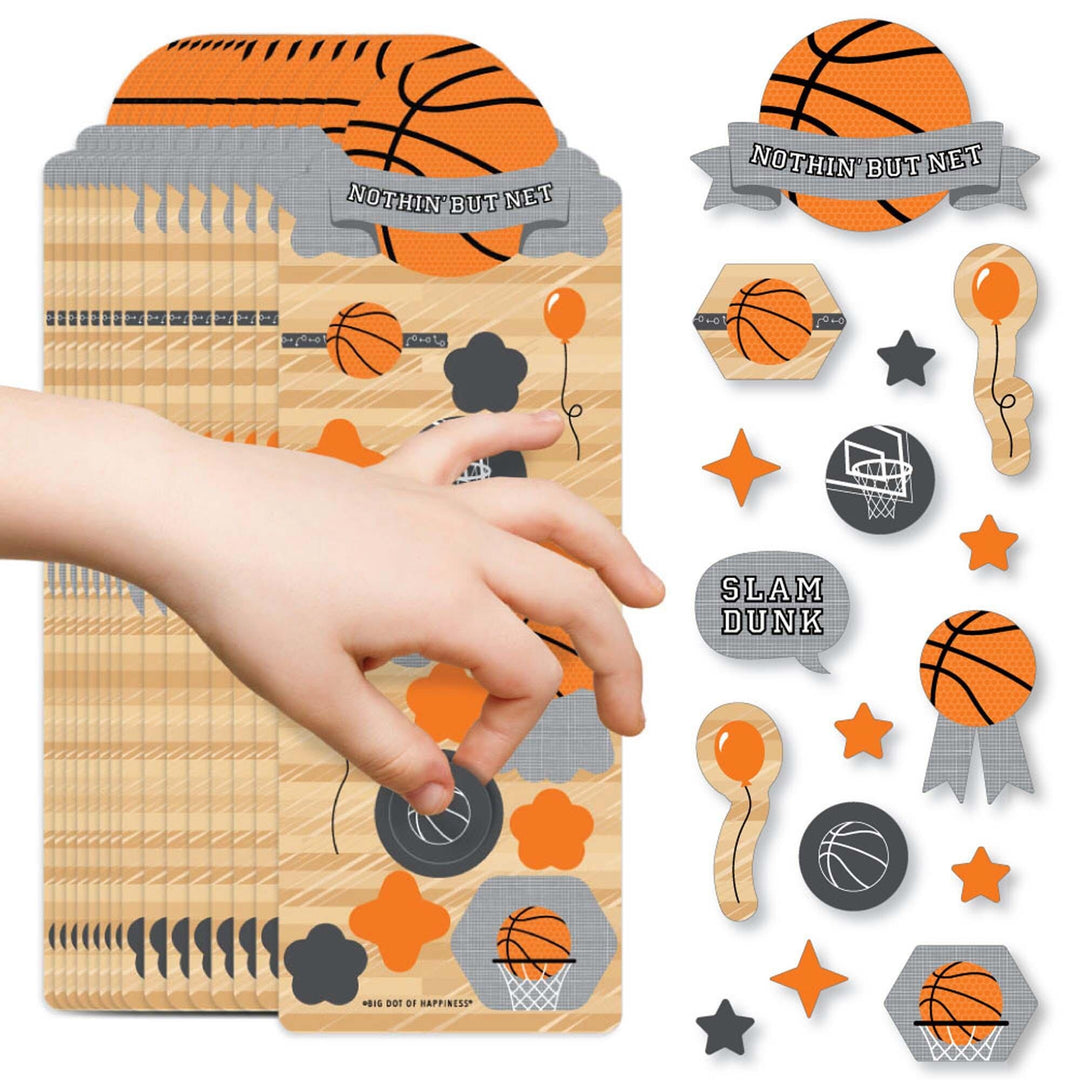 A collection of basketball-themed stickers in various shapes including basketballs, hoop seals, and stars being placed on a surface by a child's hand.