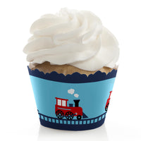 A cupcake with a train-themed cupcake wrapper featuring a blue background and a red steam train design.