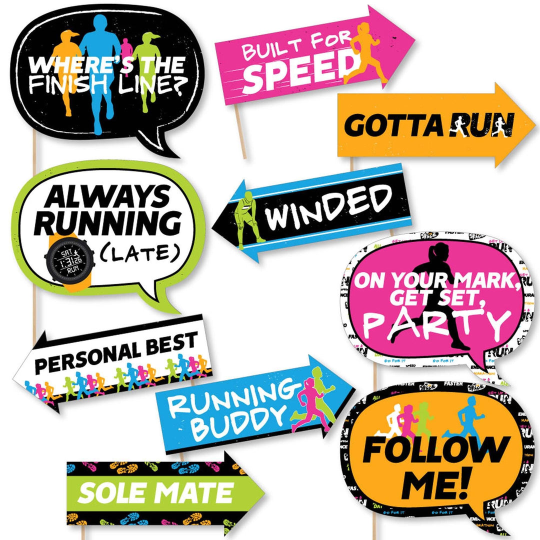 A collection of colorful photo booth props with running-themed phrases printed on them, including props like 'Where's the Finish Line', 'Built for Speed', and 'Gotta Run'.