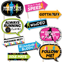A collection of colorful photo booth props with running-themed phrases printed on them, including props like 'Where's the Finish Line', 'Built for Speed', and 'Gotta Run'.