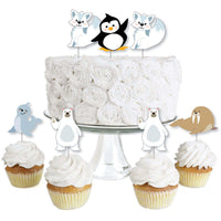 A set of dessert cupcake toppers featuring Arctic polar animals, including cutouts shaped like penguins and seals, attached to clear treat picks, displayed on a white cake and cupcakes.
