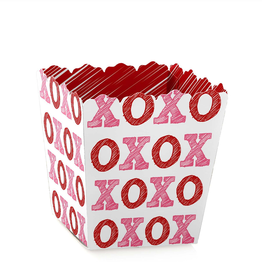 A Valentine's Day square-shaped party favor box with a red 'XO' pattern design, with a small amount of space for candies.