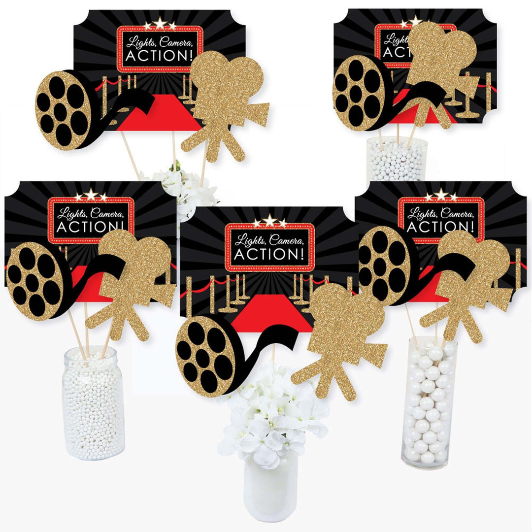 A set of Red Carpet Hollywood themed centerpiece sticks with various movie-related shapes displayed in a gradient, ready to be placed in vases on a table.