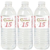 Three water bottles with pink and gold 'Mis Quince Anos' sticker labels attached to them.
