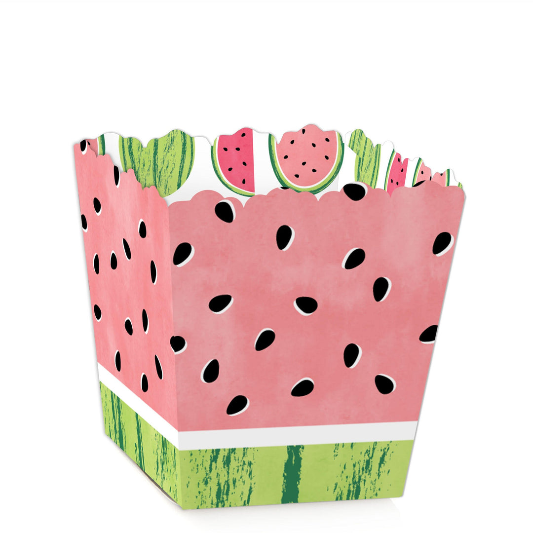 A mini favor box with a watermelon design, featuring a pink base with green top and black seed patterns.