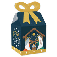 A square favor gift box with a nativity scene design, featuring a gold bow on top and crease lines for assembly.