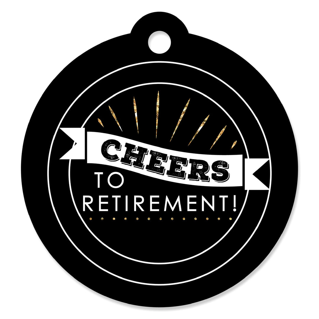 A round, black card stock gift tag with 'CHEERS TO RETIREMENT!' written in white and gold, with a hole at the top for hanging.