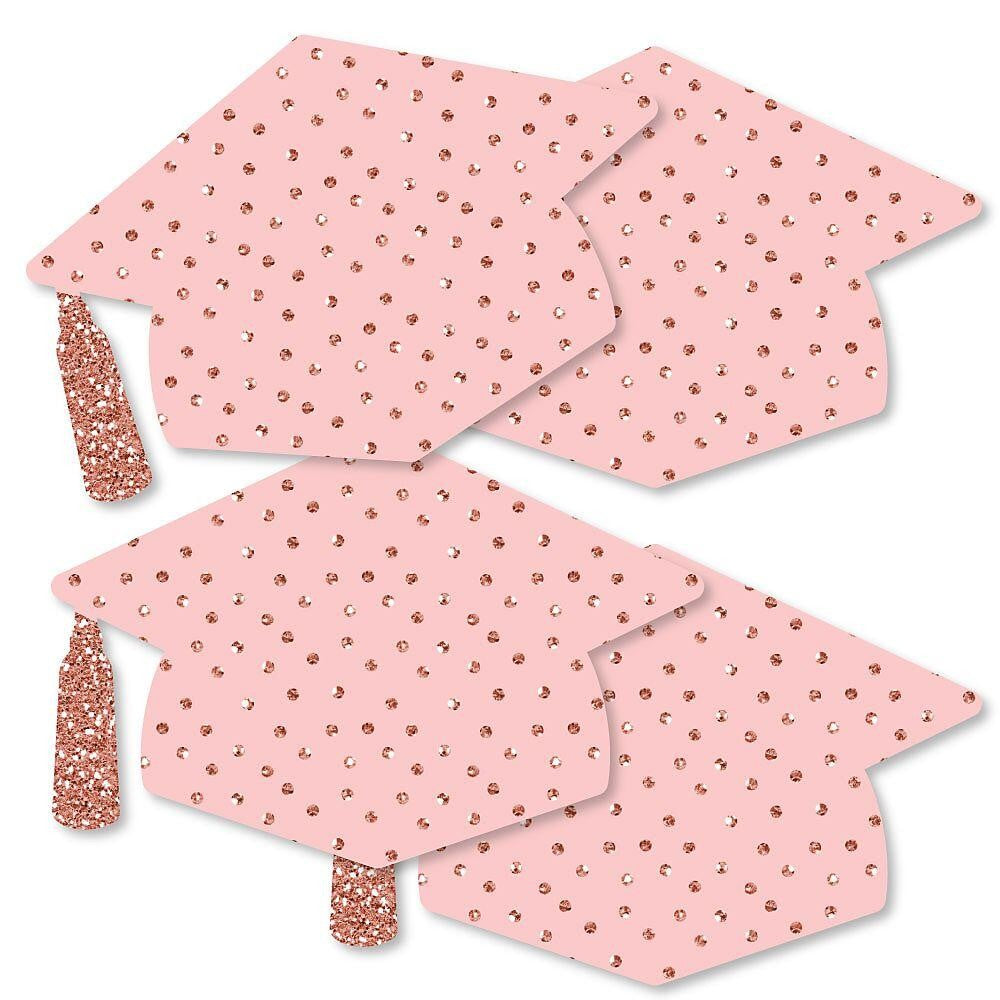 A set of rose gold graduation cap-shaped decorations for a party with a pattern printed on them.