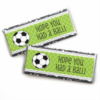Two candy bar wrappers with soccer ball design and the phrase 'HOPE YOU HAD A BALL' printed on them.