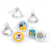 A collection of round candy labels with Back to School designs, including images of pencils, paper, and a school bus, displayed on Hershey's Kisses-shaped candies.
