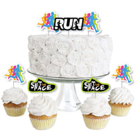 Dessert cupcake toppers with running-themed designs, including clear treat picks and colorful paper cutouts, displayed on a cake and cupcakes.